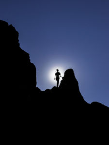 Silhouette of Timm Derrickson standing on a cliff edge at Palo Duro canyon